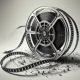 film reel, digital code, minimalistic background, high contrast, monochromatic line art